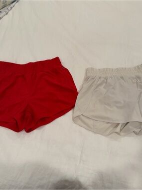 Two CRZ Yoga high waisted running shorts. 3”. Color: deep red & bone